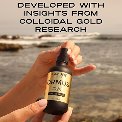 Hand holding Kiro Ormus Gold at ocean